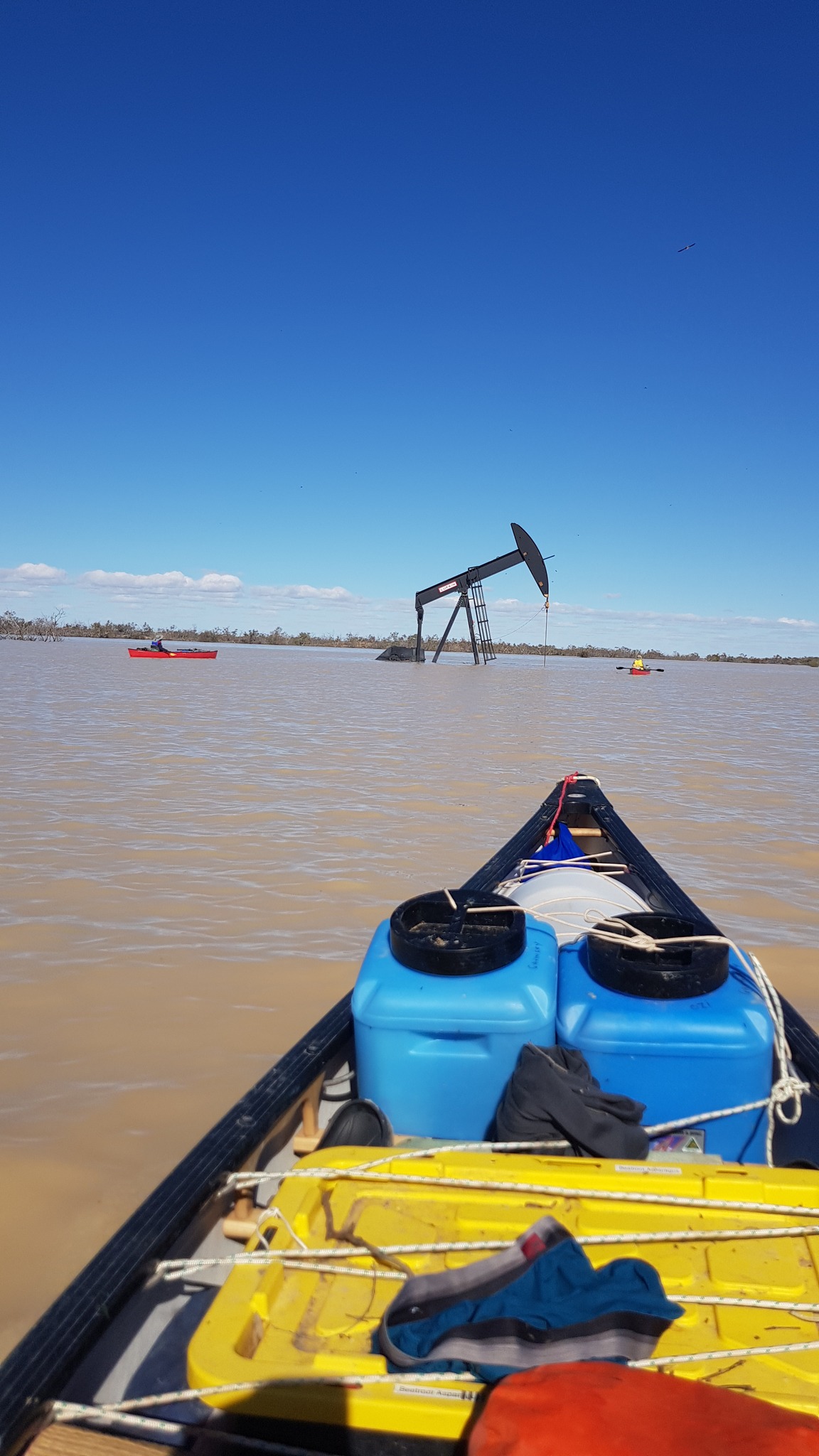 Image of a pumpjack operated by Beach Energy inundated in about a metre of floodwaters, with its boom and frame exposed (Photo by Glen Hughes).