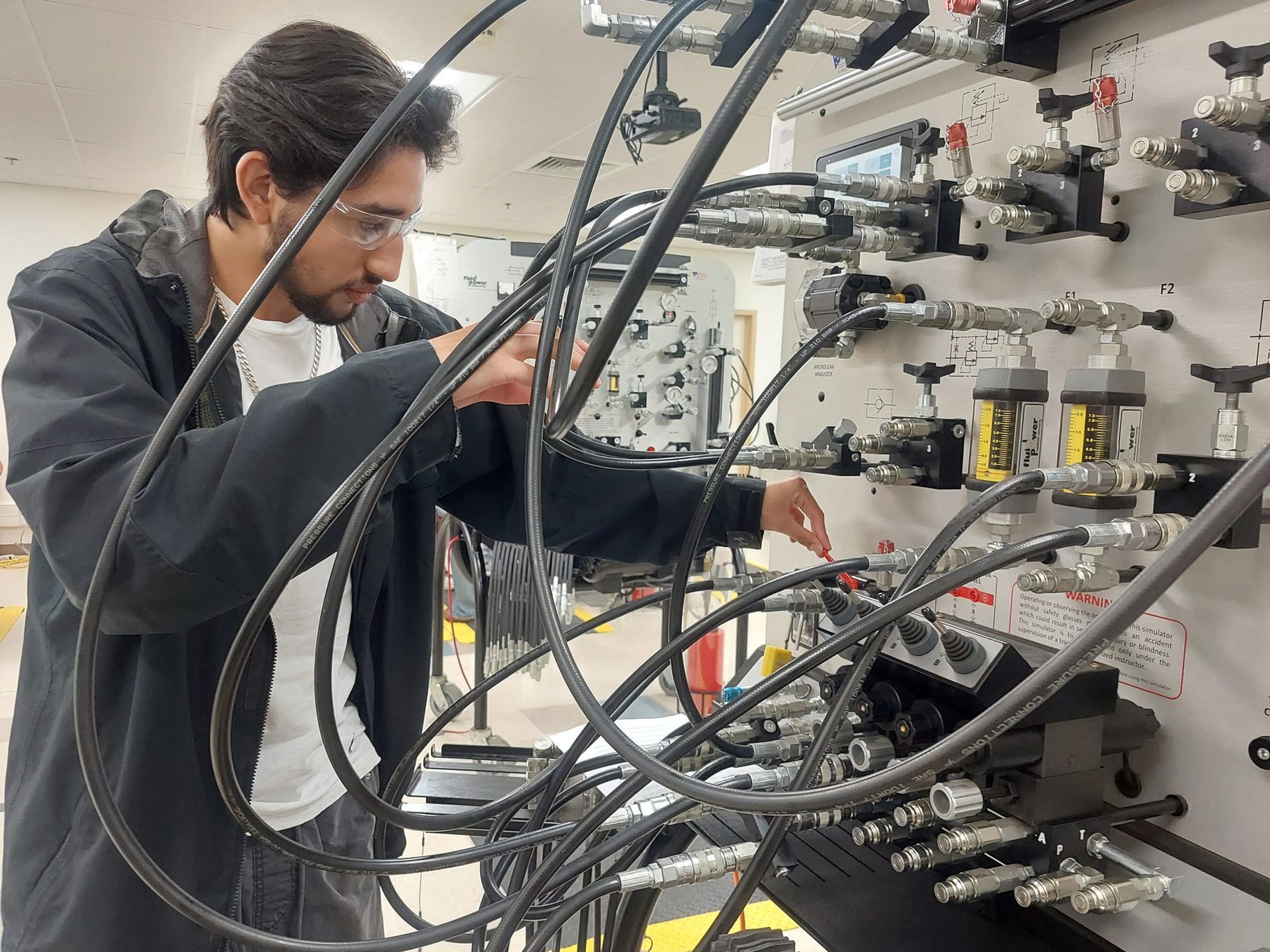 Dylan Ruiz, a 17-year-old senior at Legacy High School in Midland, Texas, works through a training scenario on preventing oil leaks during his class on pumps, compressors and mechanical drives at Midland College’s Petroleum Energy Program. Photo credit: Jordan Gass-Pooré for 