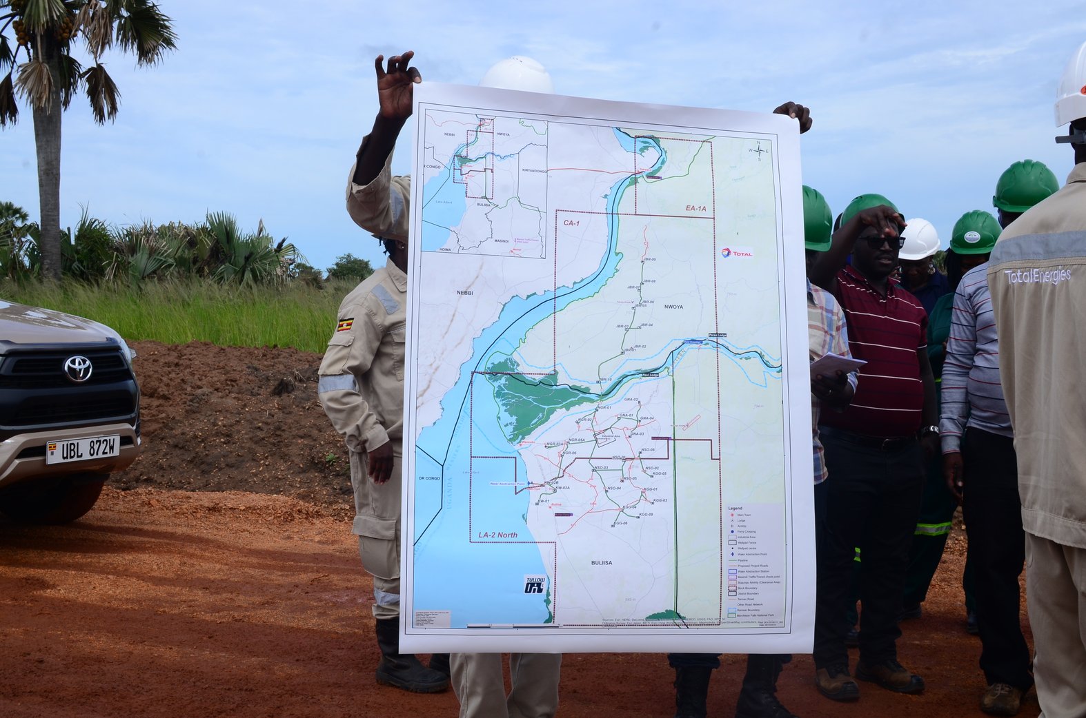 A TotalEnergies official displays the Tilenga project map highlighting its location inside the national park