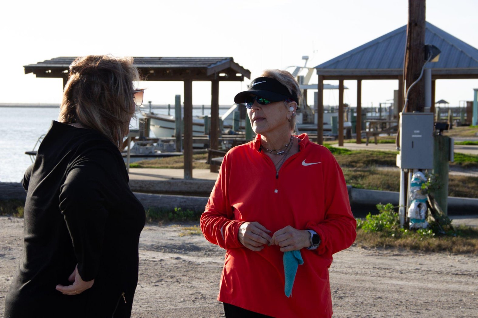 Lynne Porter (right) speaks to former Coastal Watch Association Executive Director Cyndi Valdes (left) as she takes a break from her afternoon jog. (Alex Ip/The Xylom)